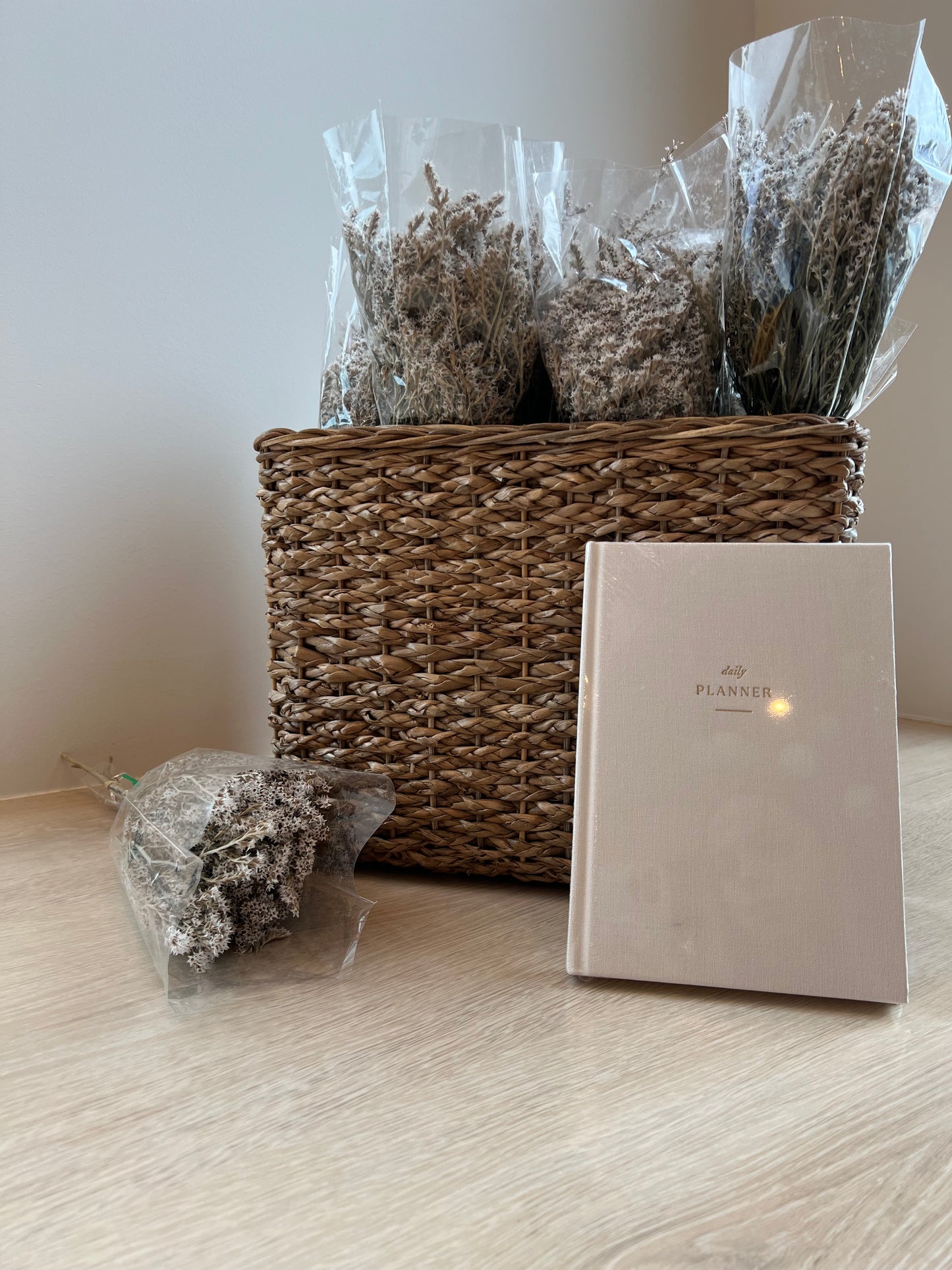 Daily planner book, dried flowers in wicker basket in background