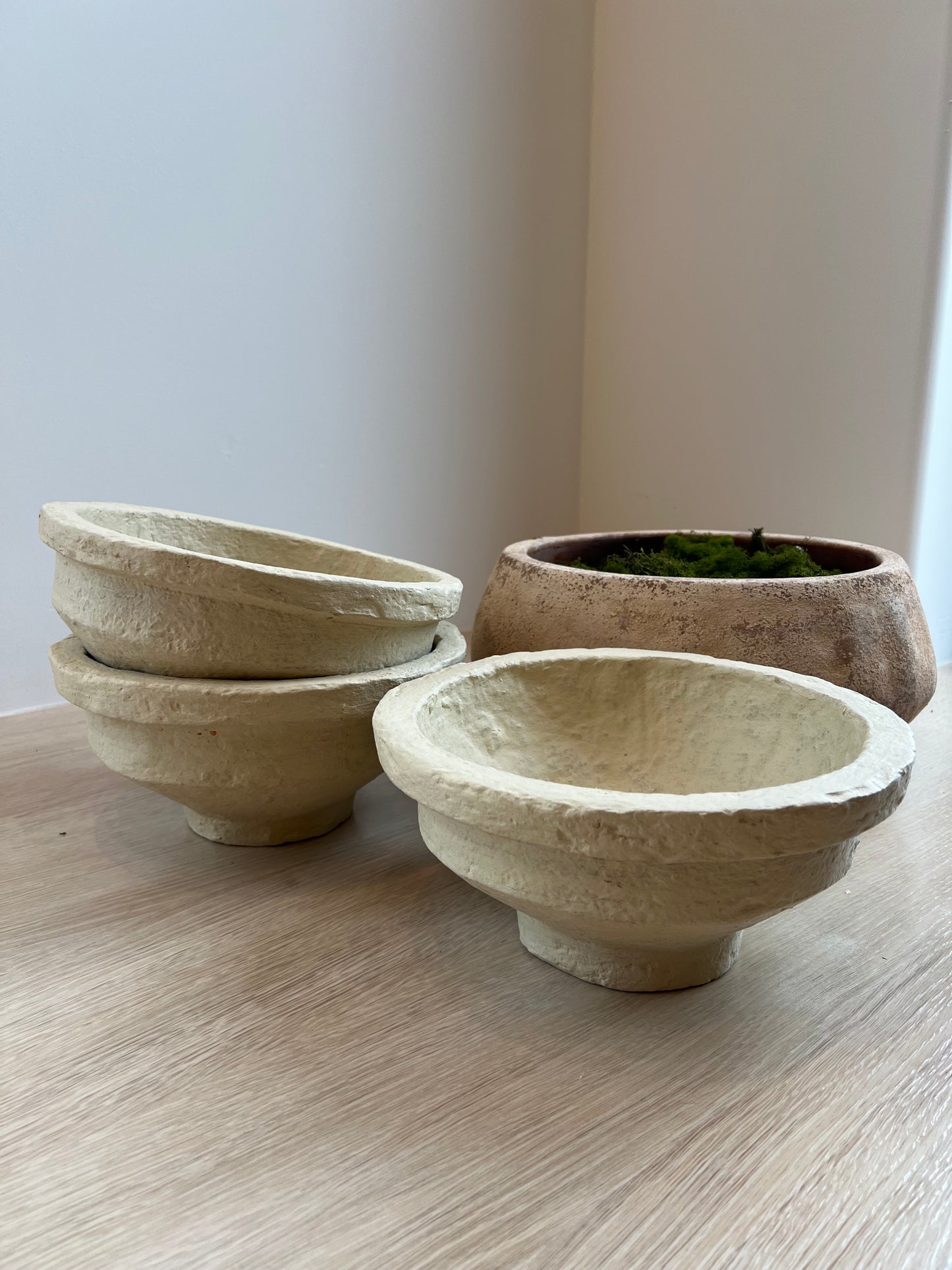 Two ceramic bowls on a light wooden surface