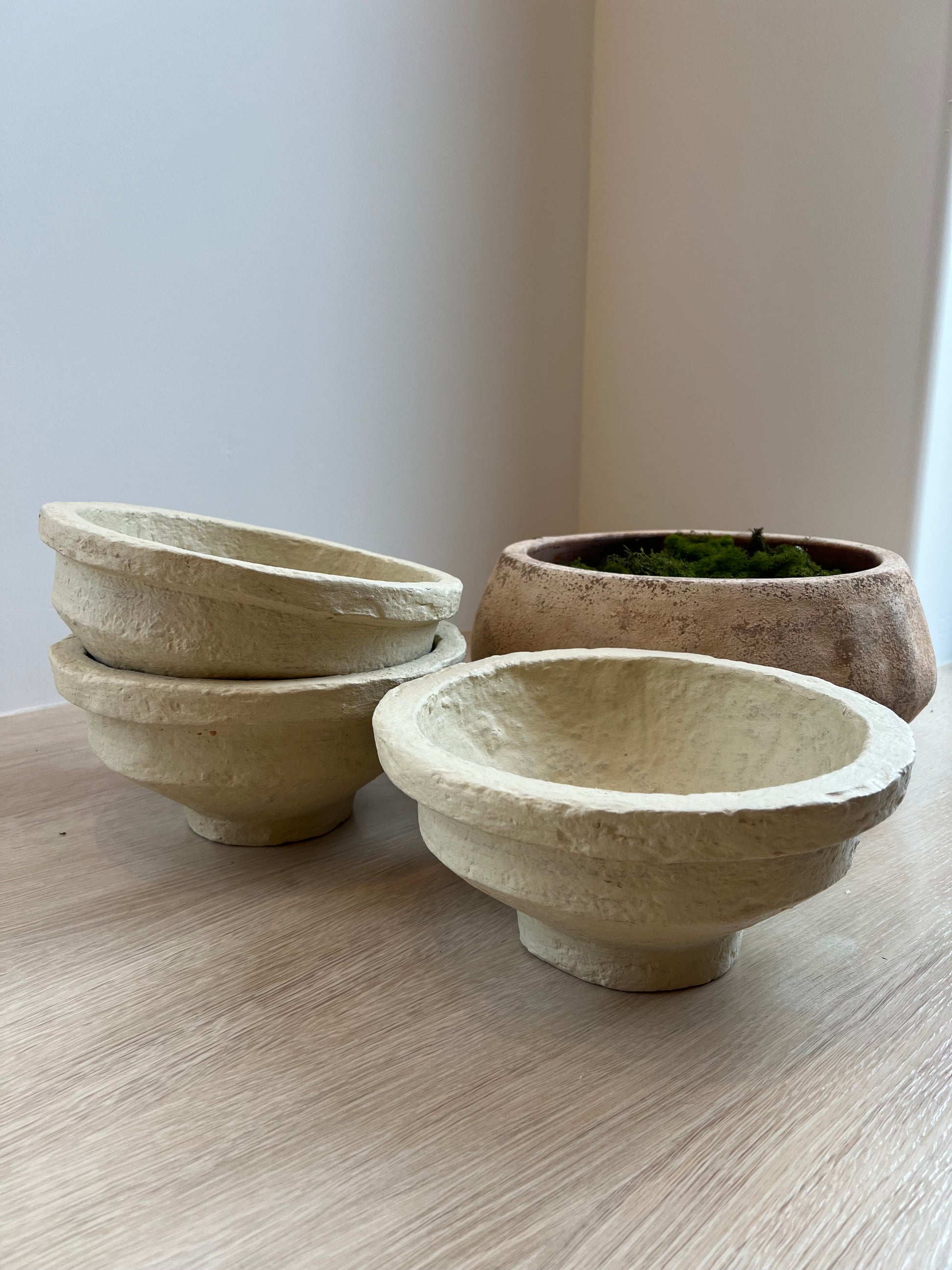 Two ceramic bowls on a light wooden surface