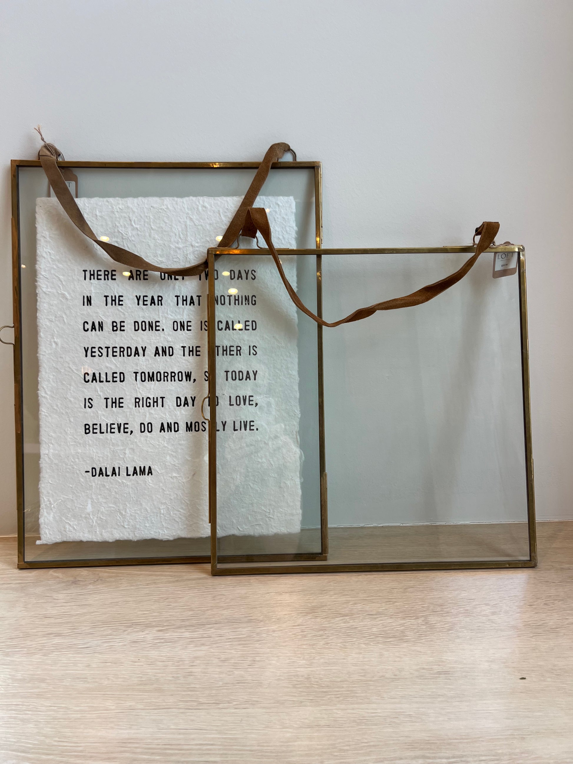 Decorative glass box with a quote on a light wooden surface