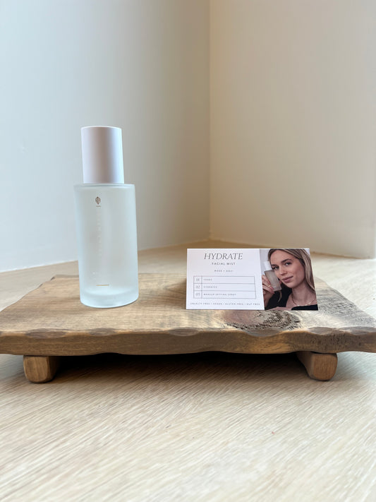Hydrate Facial Mist on a wooden surface with a blurred background