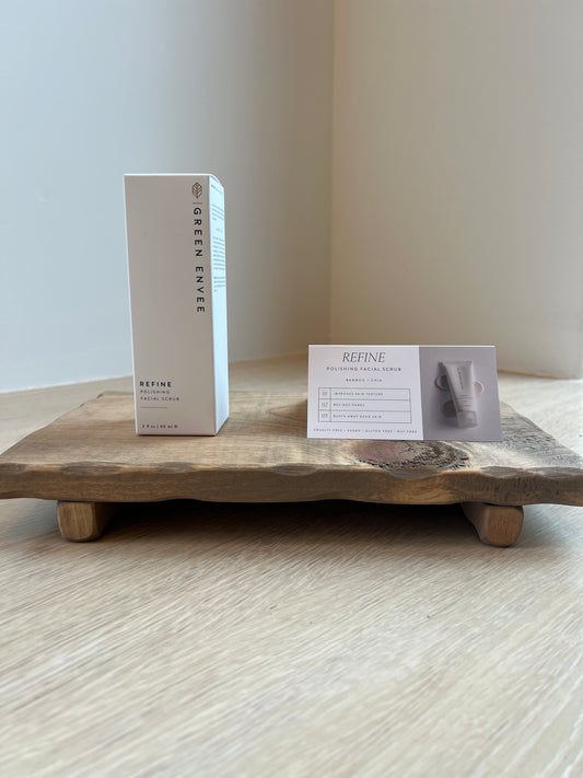 Refine Polishing Facial Scrub From Green Envee product box on wooden tray