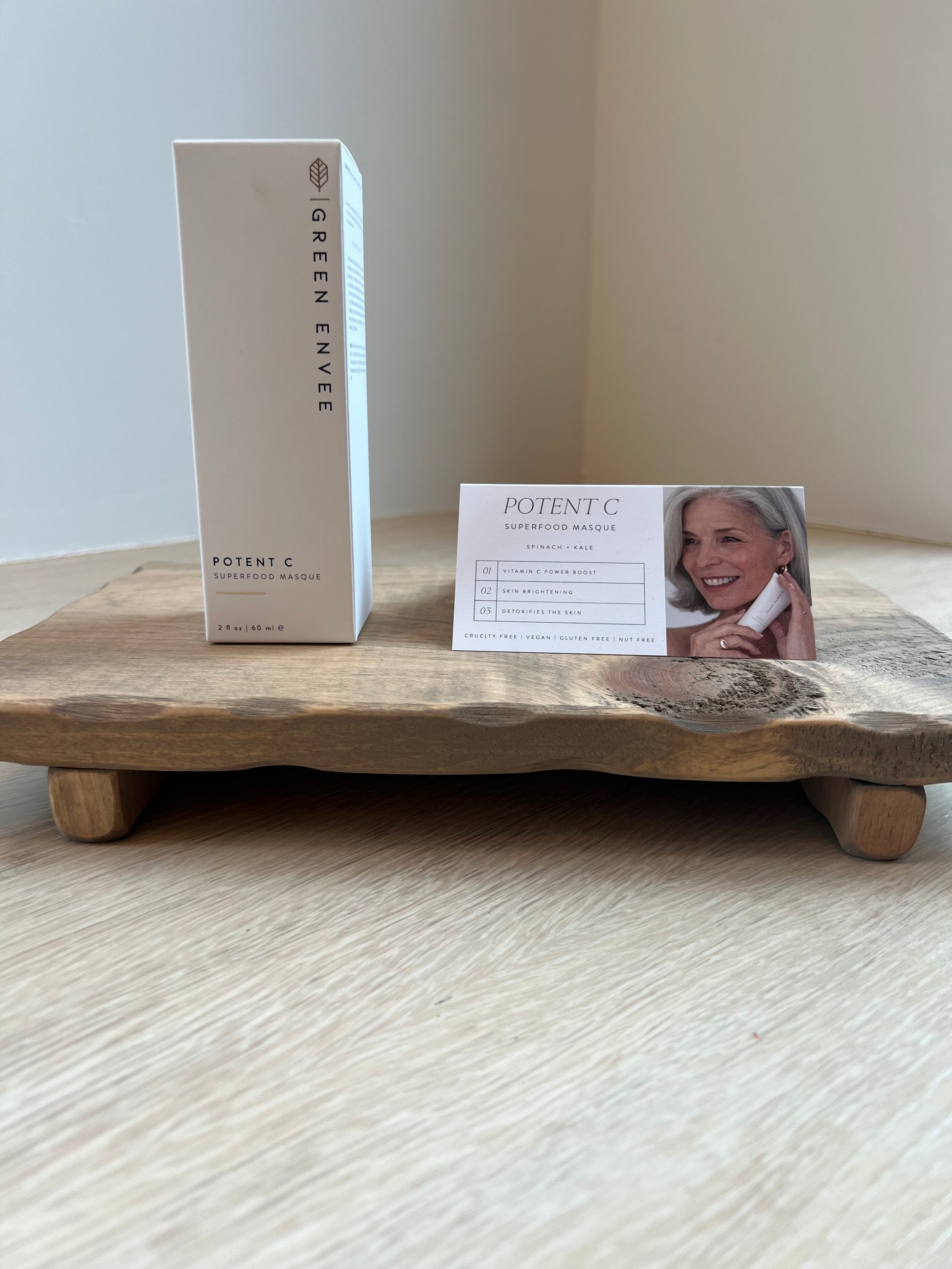 Product packaging with a card on a wooden surface