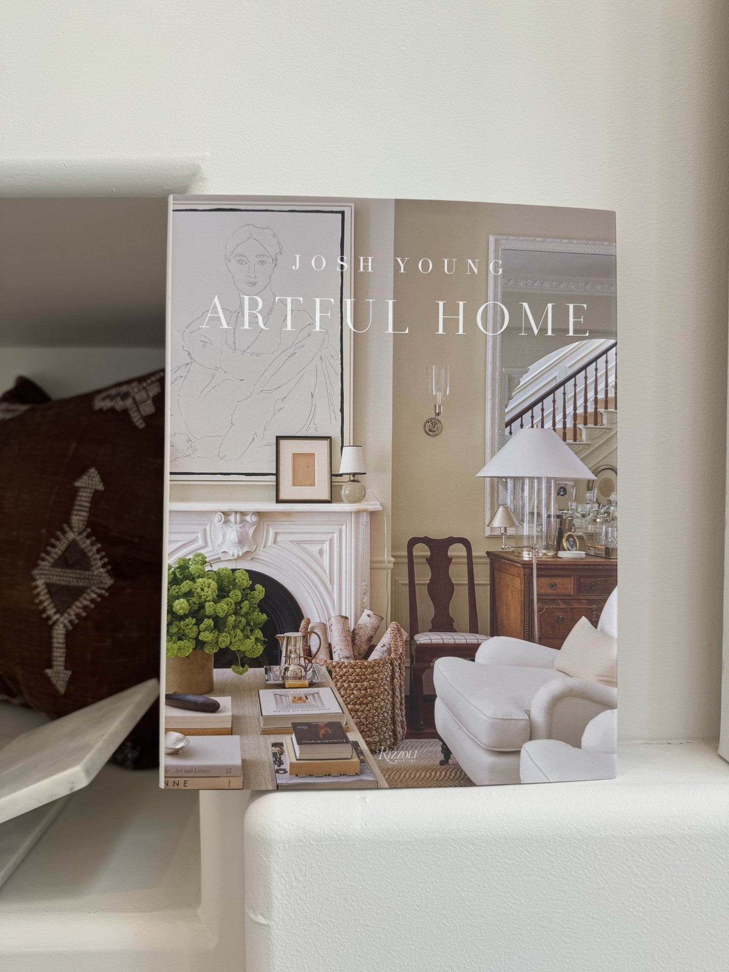 Book titled 'Artful Home' by Josh Young with interior design images on the cover.